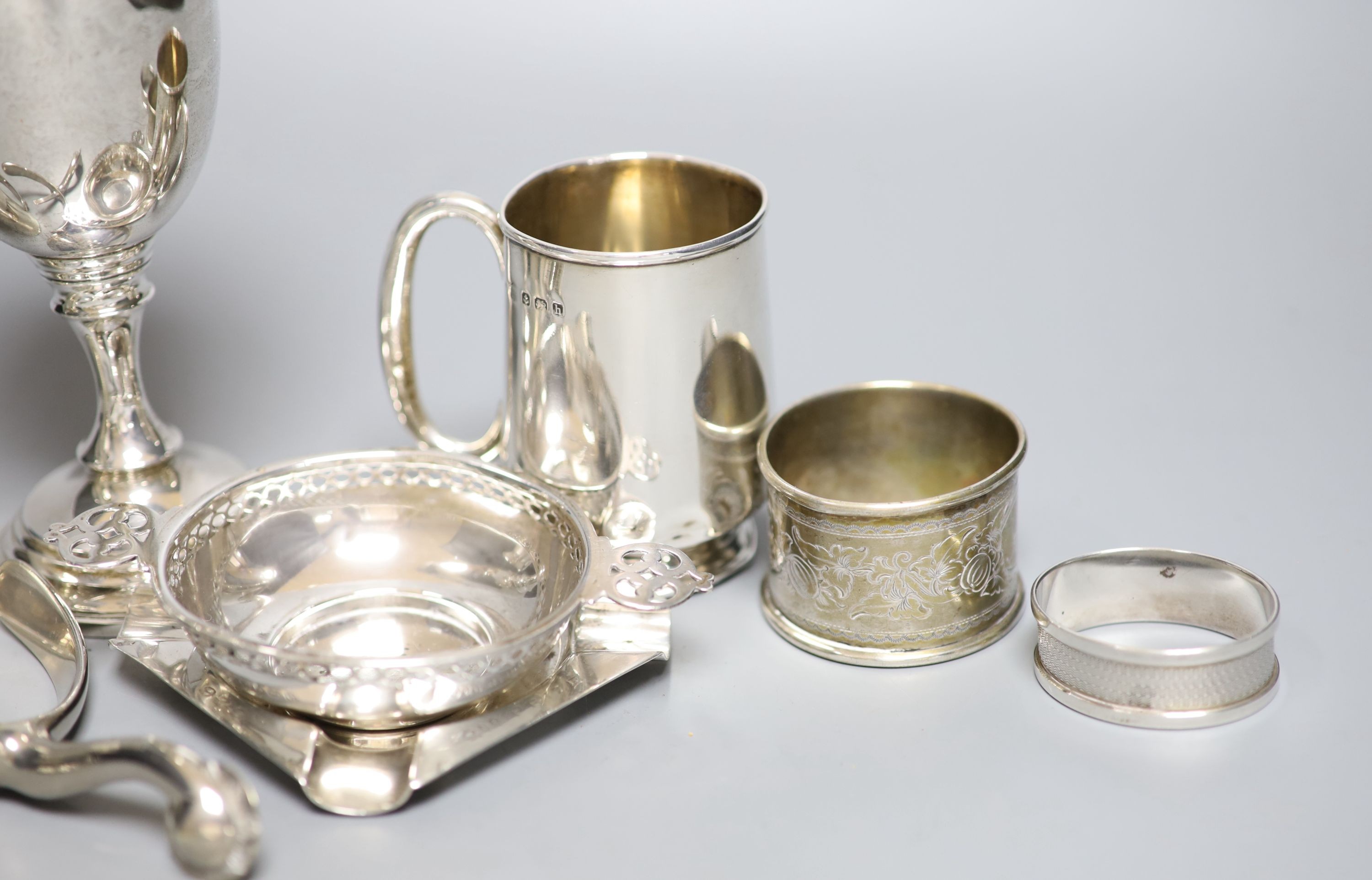 Mixed small silver lot to include a pepper mill, cream jug, christening mug, goblet, etc and a pair of metal spurs.